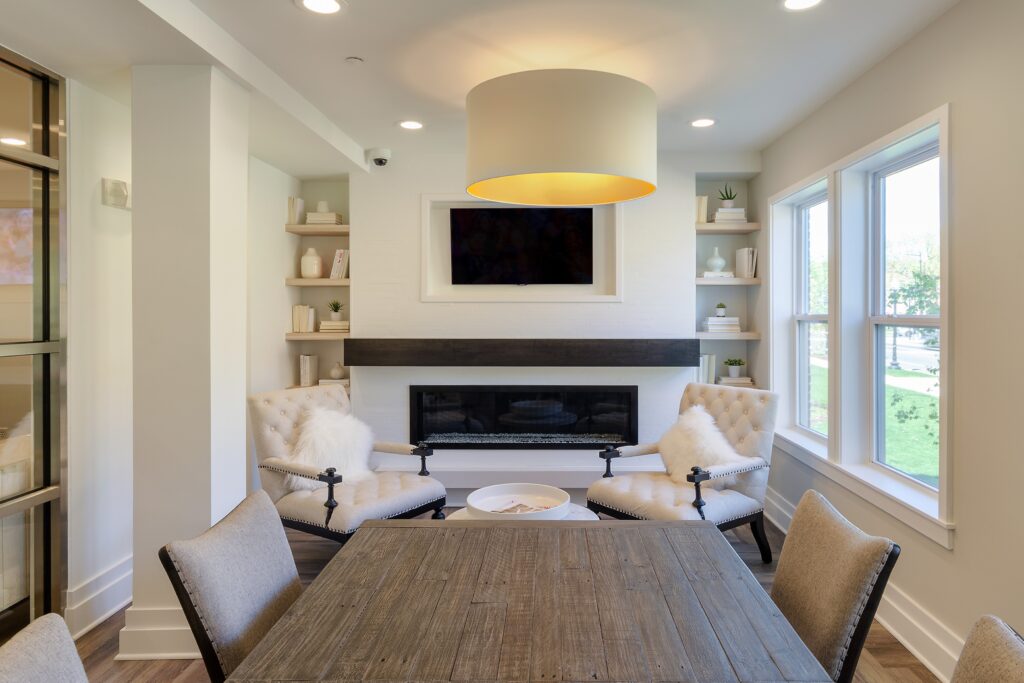 Table and arm chairs around a fire place