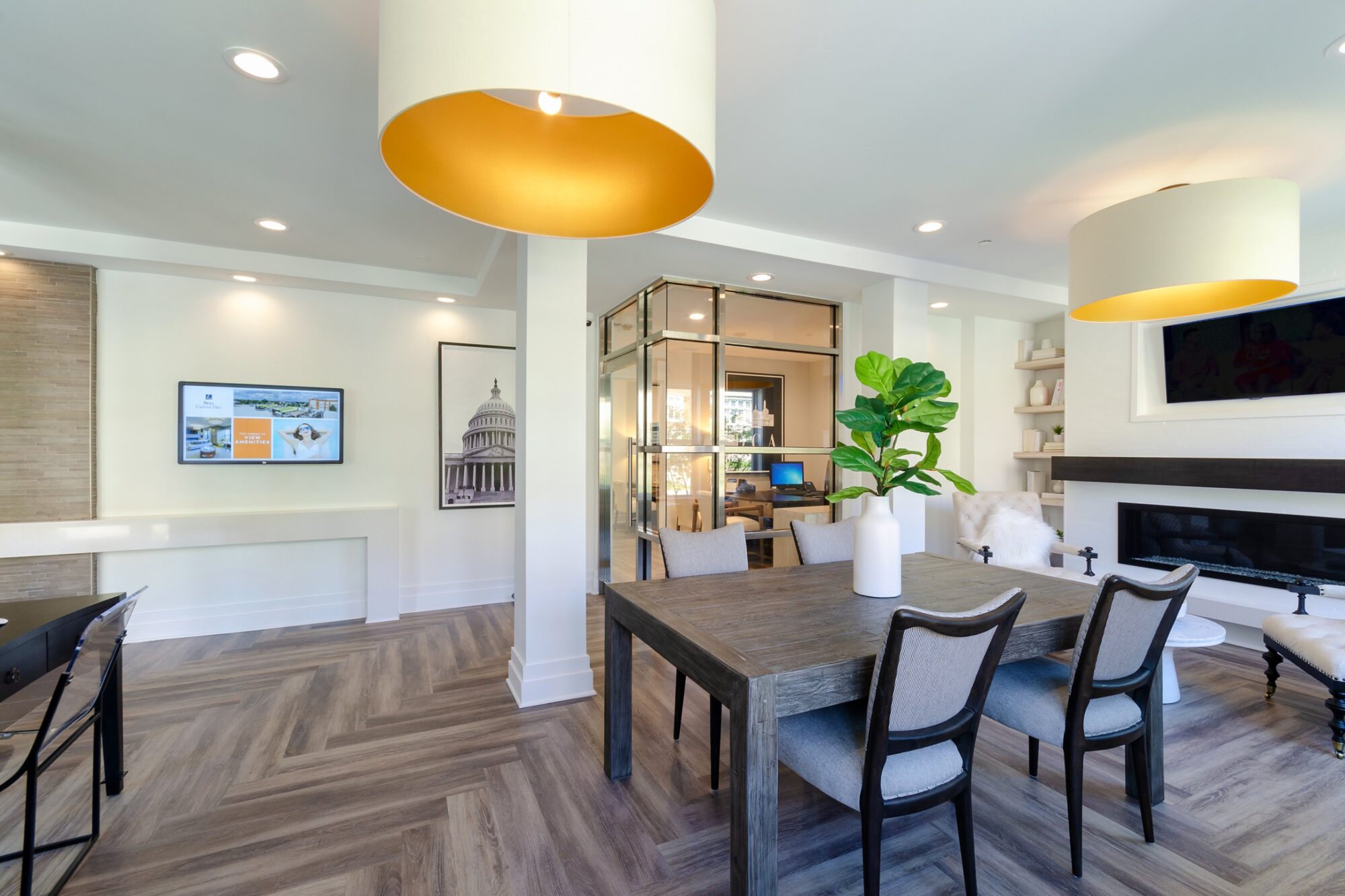 Clubhouse lobby with tables, arm chairs, and fire place