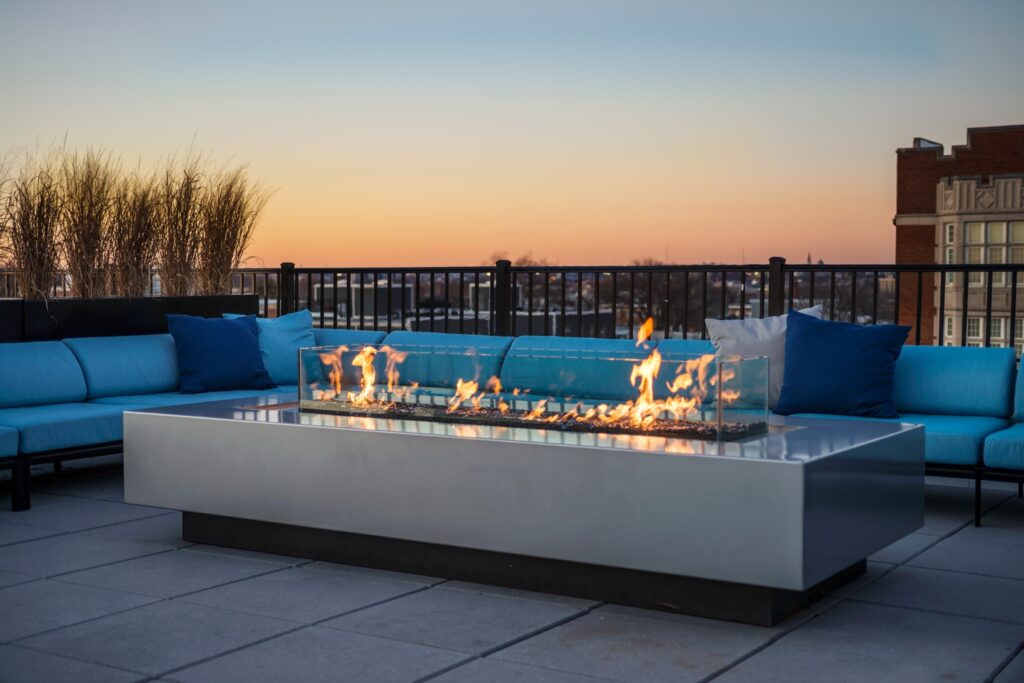 Fire pit and sofa on a rooftop patio