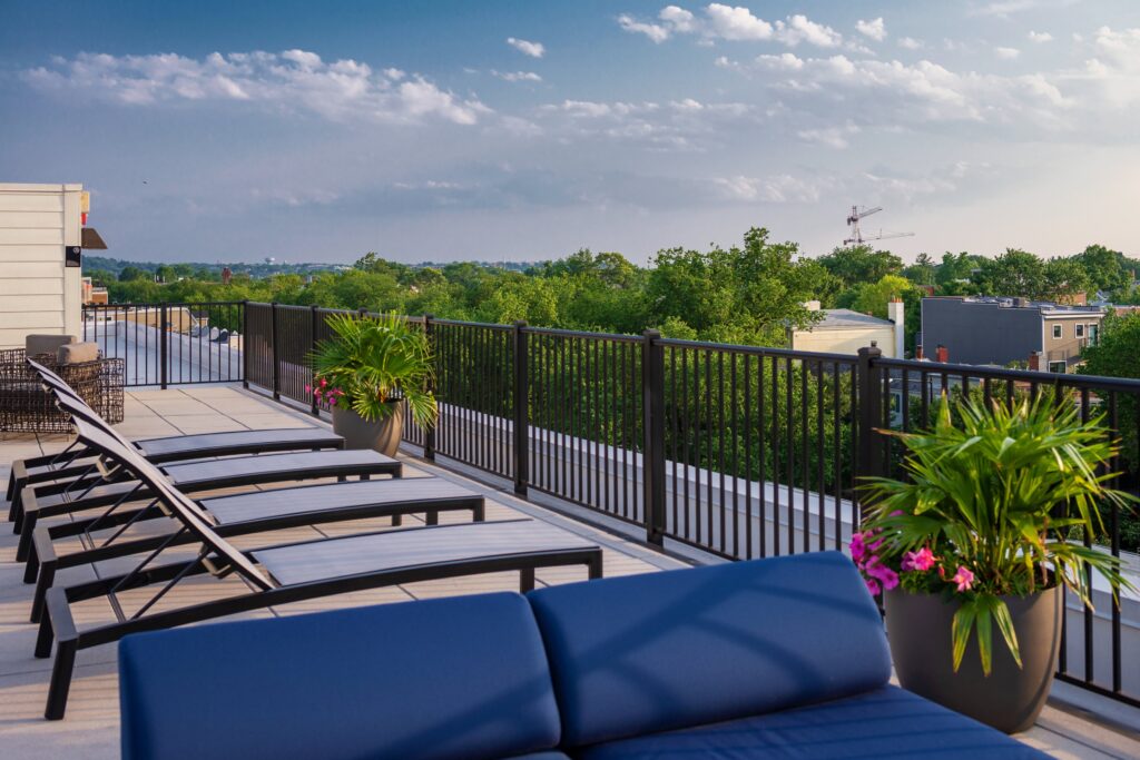 Rooftop patio with reclining chairs and view over the trees