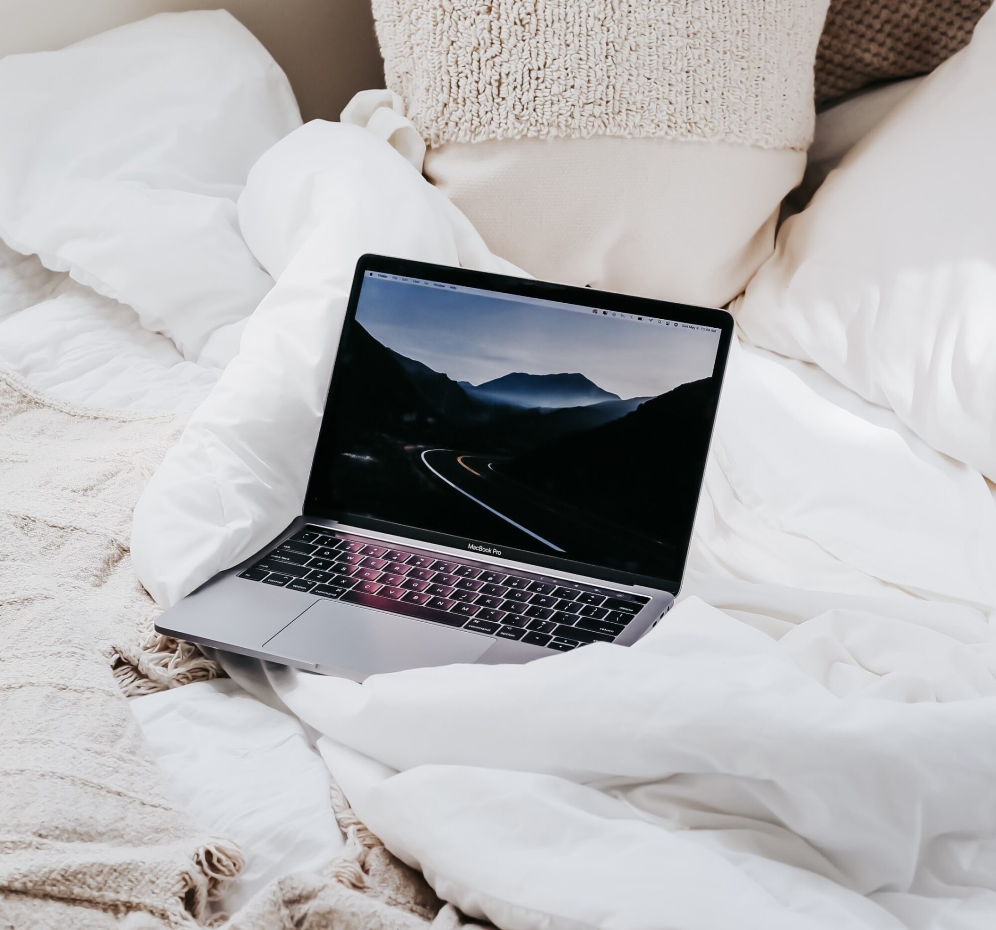 Laptop sitting on a bed